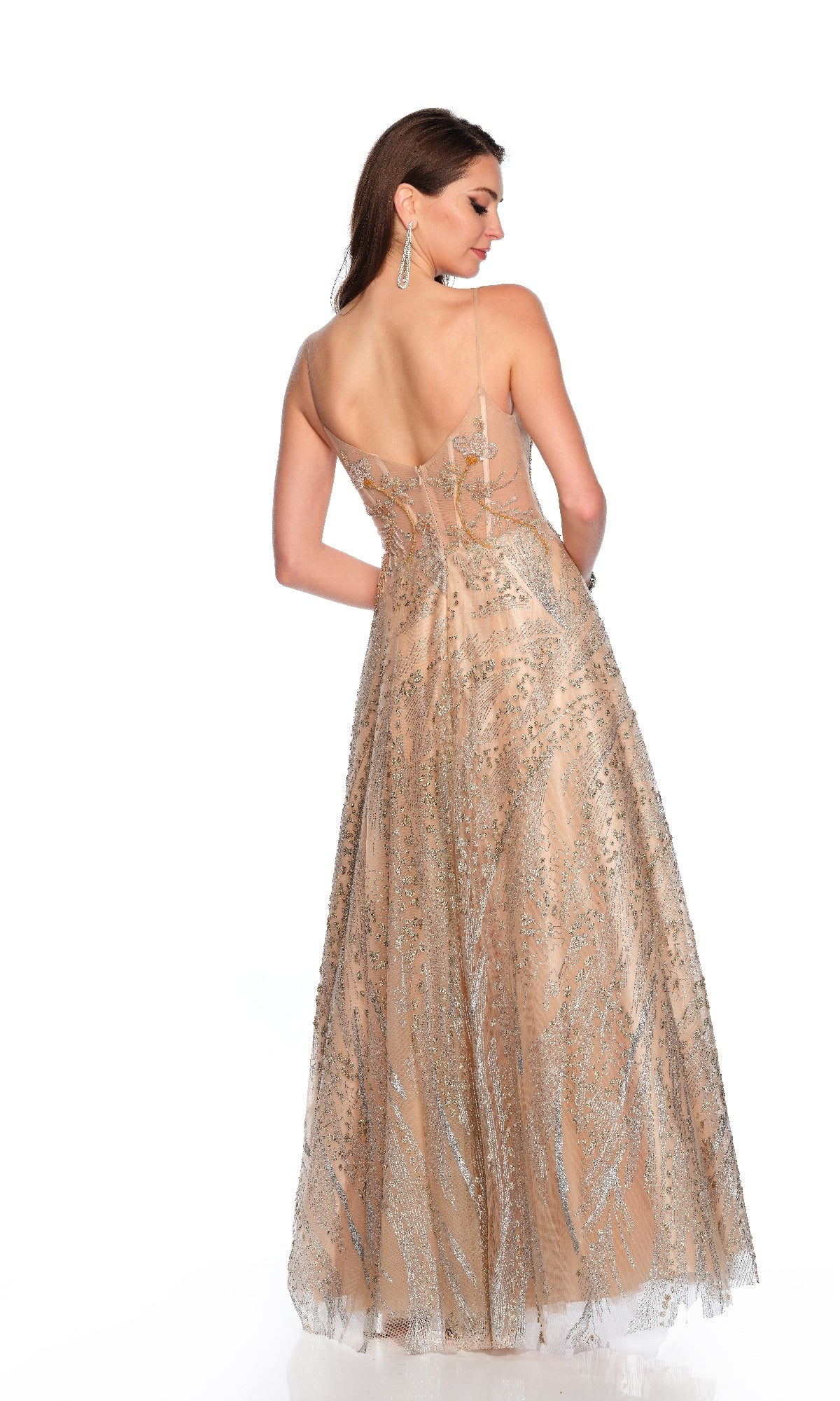 A woman wearing the Dave & Johnny 11534 long gold prom dress stands with her back to the camera, showcasing its floor-length silhouette and thin straps.